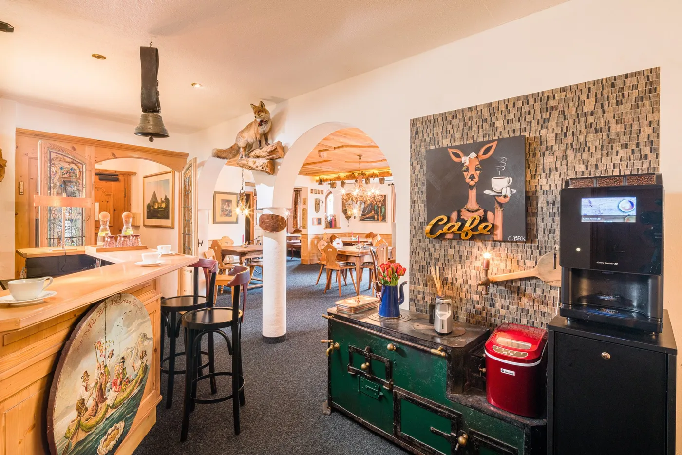 The bar corner in the Bauernstube of the Sunneschlössli with coffee machine and antique stove