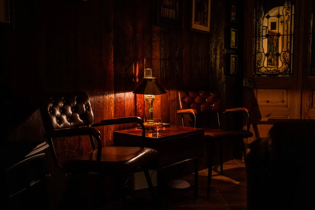 Armchair and table lamp in the Orient Express bar in the evening